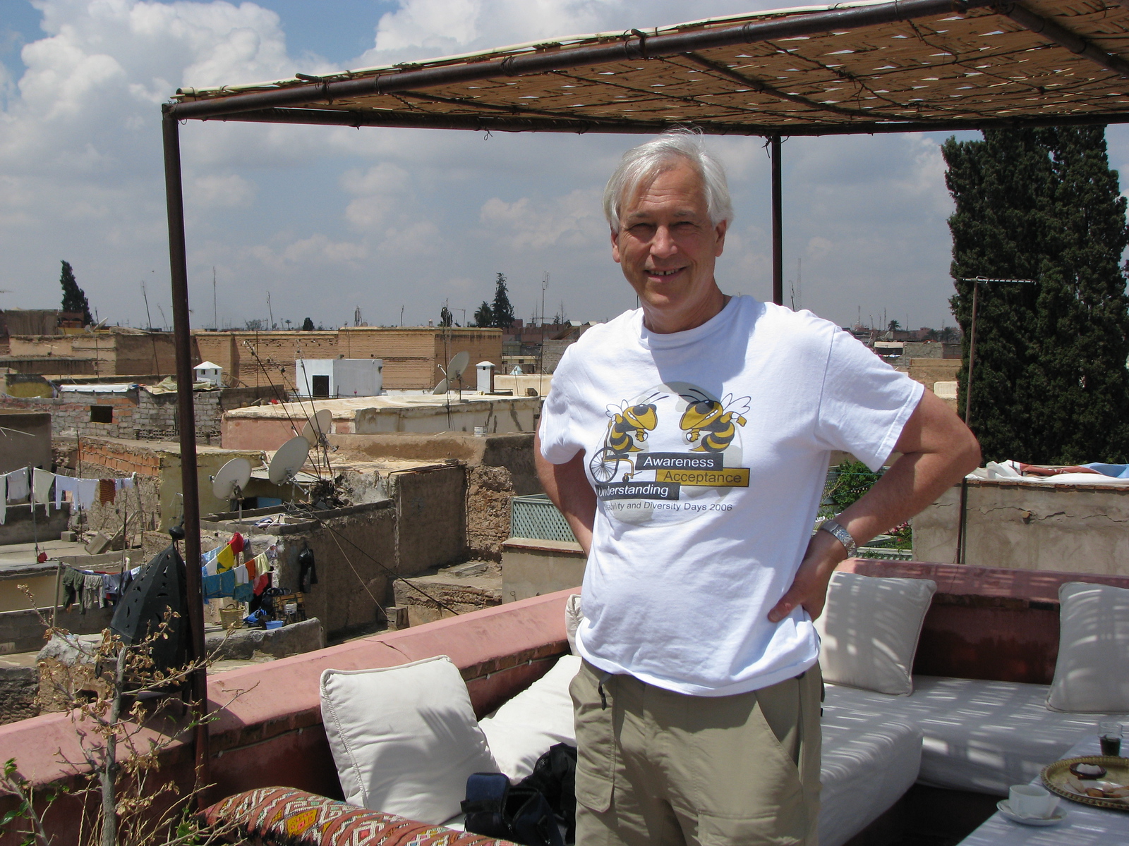Evans Harrell standing on a shaded rooftop terrace overlooking Marrakech
