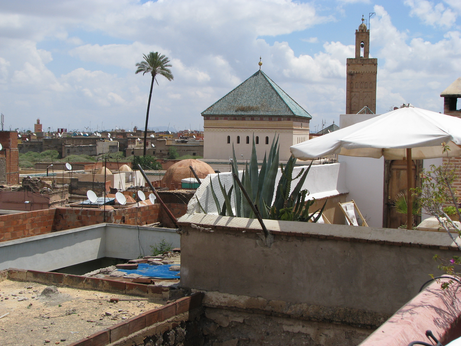 Marrakech rooftops with a minaret rising in the distance